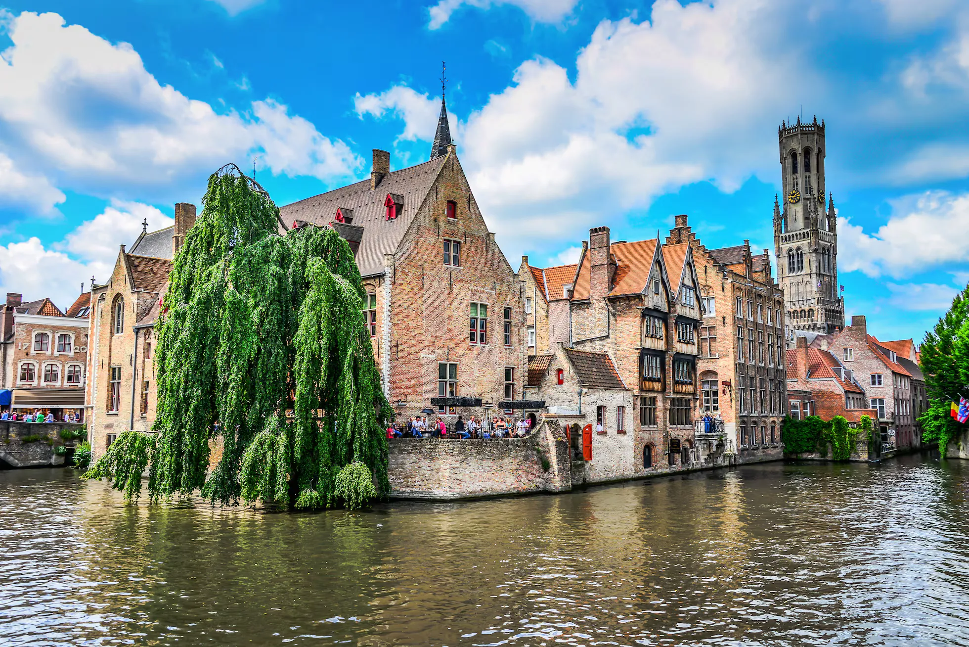 A canal in Bruges, brick gables leaning over still water.